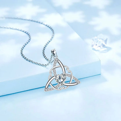 Close-up of a geometric Celtic knot pendant necklace for women in an electroplated blue finish on a copper base.