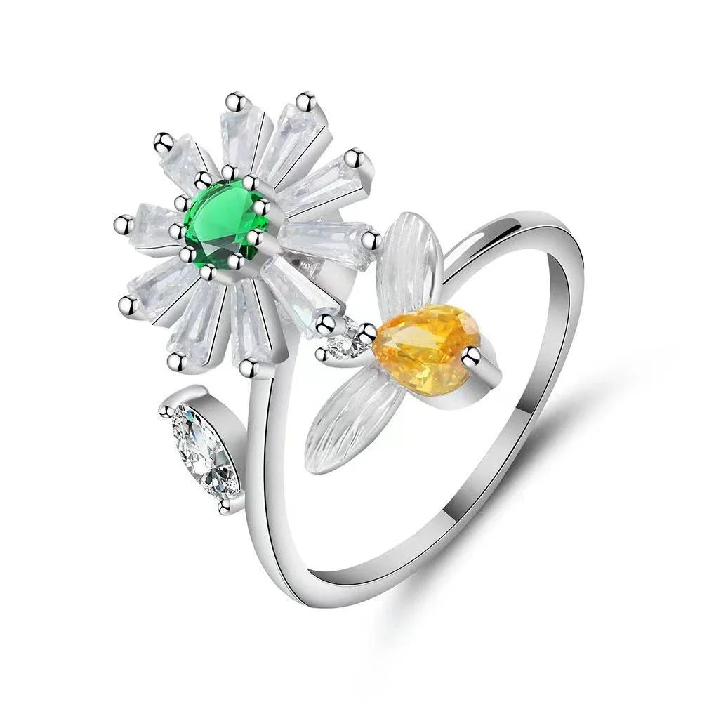Adjustable spinner ring with rotating floral, geometric, and nature-inspired motifs for women's fashion and stress relief