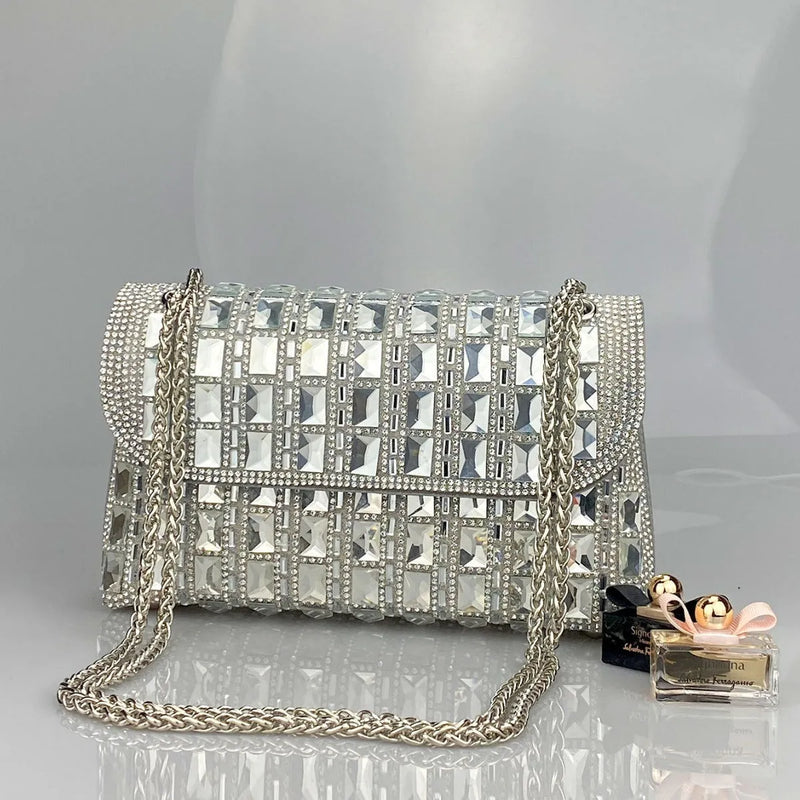 Ladies clutch bag with shiny glass rhinestones and metal chain strap, medium-hard PU leather construction in silver, black, gold, sky blue, red, blue, or green colours, horizontal square shape for daily use, includes interior mobile phone compartment.