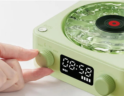 Retro-style turntable Bluetooth speaker with glowing RGB light projection on a wooden surface.