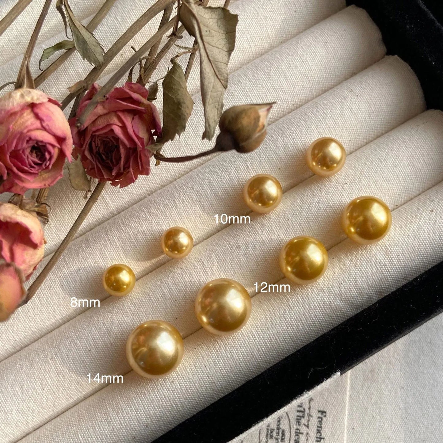 Geometric eight-point star pearl stud earrings in silver with cultured pearls, showing post-and-clasp fastening