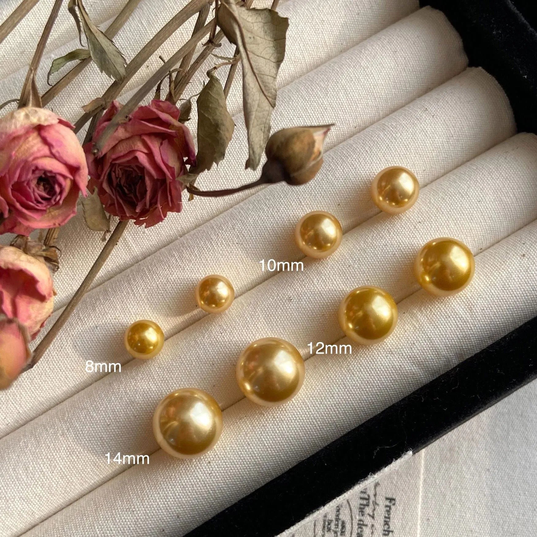 Geometric eight-point star pearl stud earrings in silver with cultured pearls, showing post-and-clasp fastening