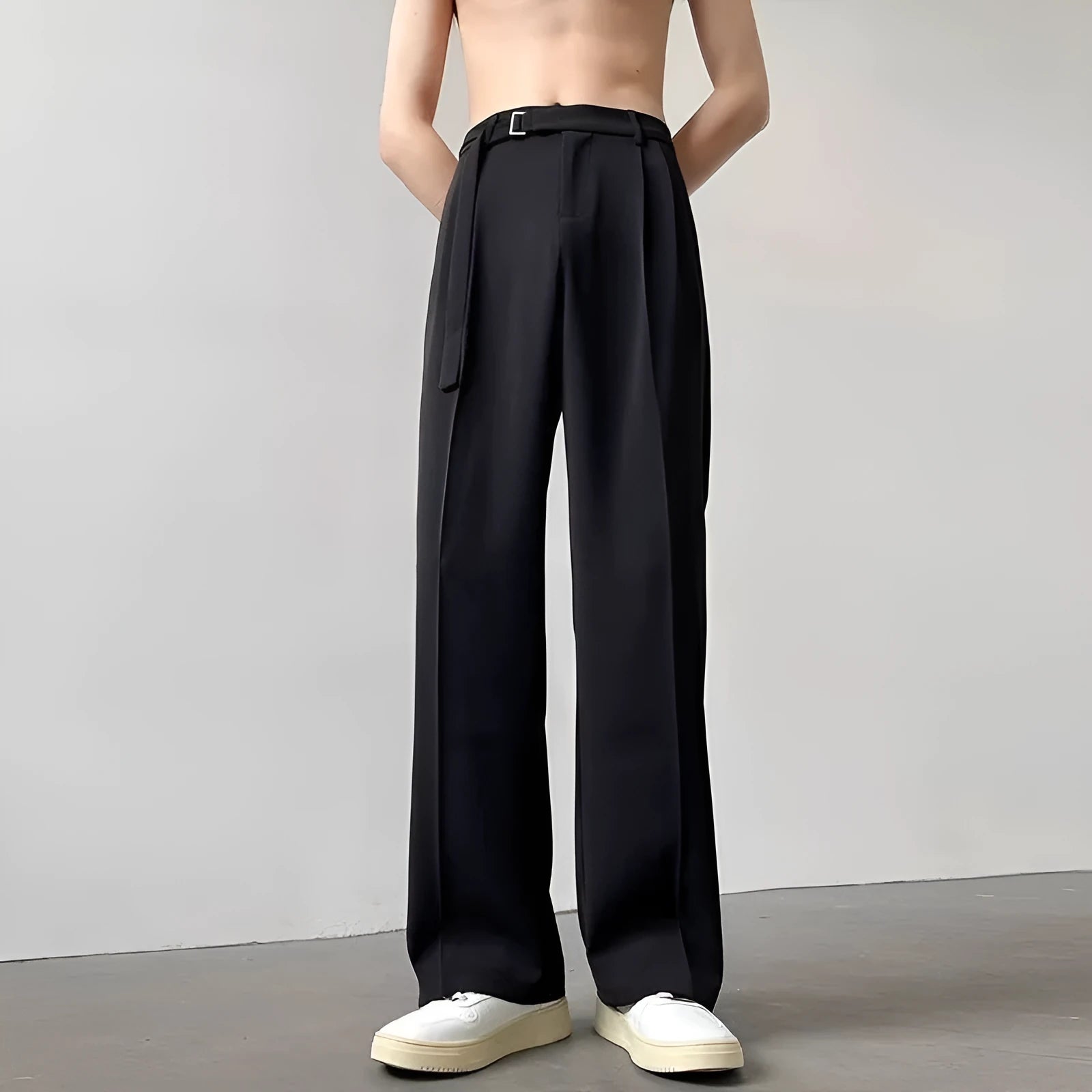 A pair of black straight leg wide fit women's trousers with a loose, casual silhouette on a hanger.