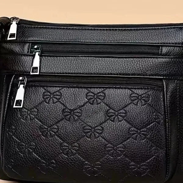 Butterfly black women's crossbody bag with horizontal square shape, slit pocket, and embossed PU detail
