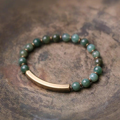 Layered stone and brass ethnic bracelet for men and women on a wrist.