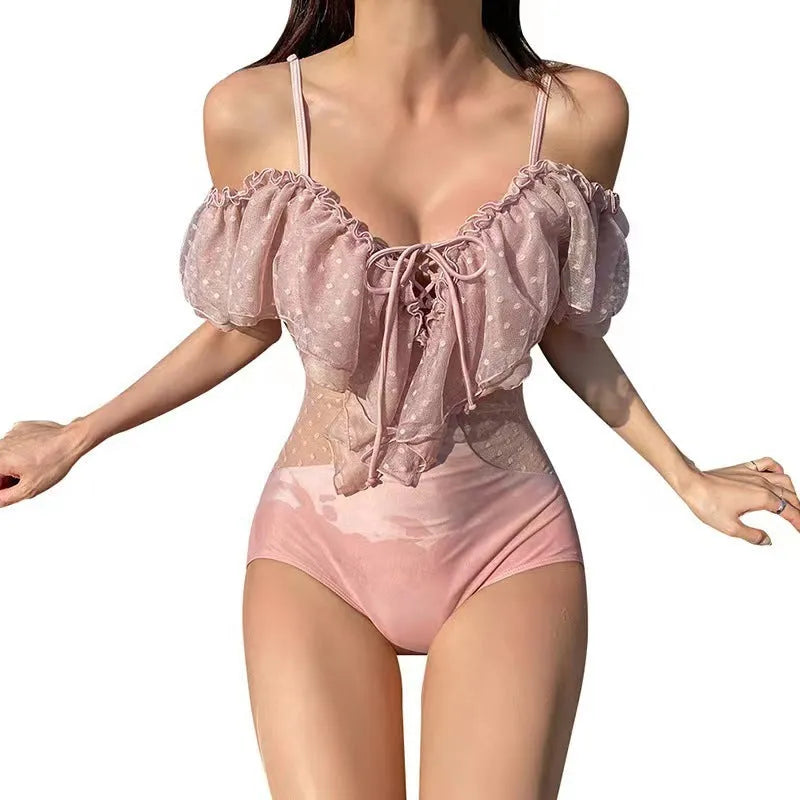Pink solid-colour one-piece swimsuit for women on a mannequin.