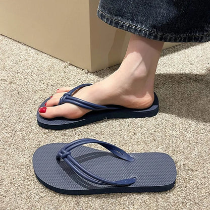 Men's PVC toe-covering flip-flop slippers on a white background, showing the injection moulded sole and available colour options.