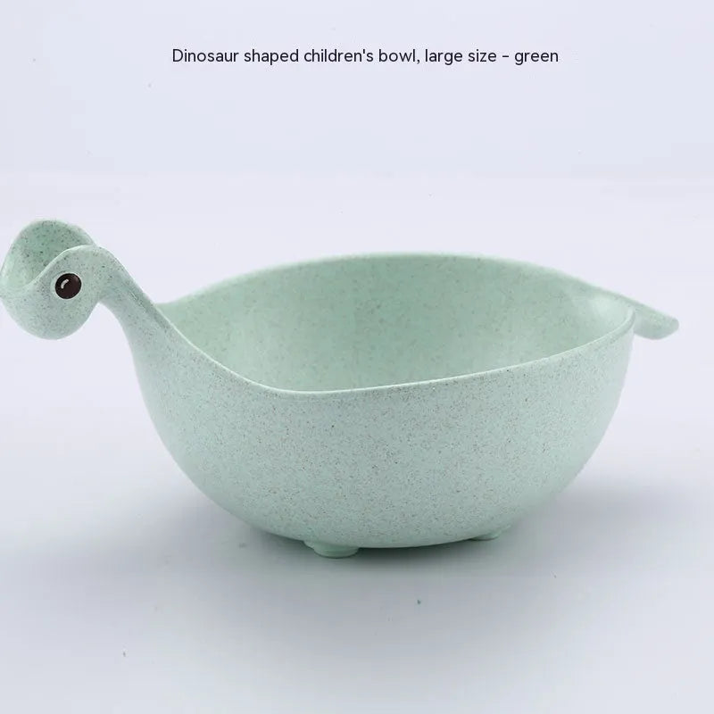 Three colourful dinosaur-shaped bowls made from wheat straw in pink, green, and beige.