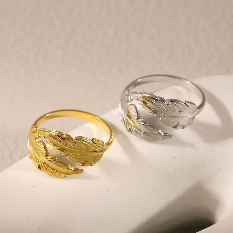 Women's stainless steel feather fashion ring with adjustable opening in silver or gold colour