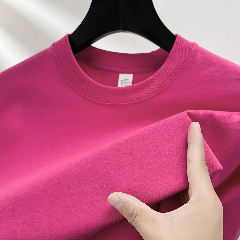 Men's thin cotton drop shoulder t-shirt on a hanger, shown in a light colour.