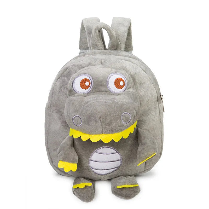 Soft blue plush children's backpack with an embroidered green dinosaur character and a soft handle.
