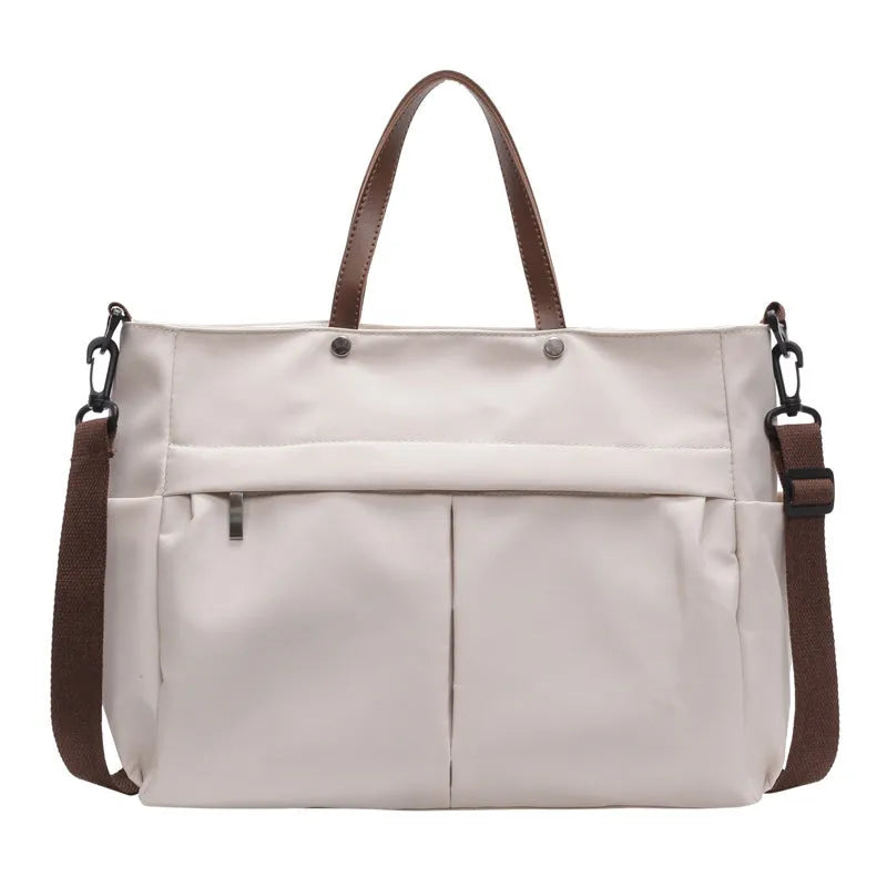 Nylon crossbody bag in five colours with 39x14x28cm dimensions and shoulder strap