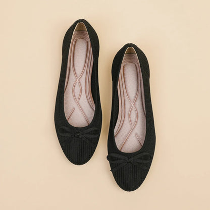 Women's round toe flat pumps with bow detail in butterfly colours showing fabric upper and shallow mouth opening