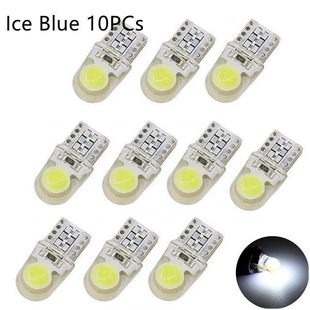 Pack of ten T10 wedge base LED car bulbs with COB chips in various colours on a white background