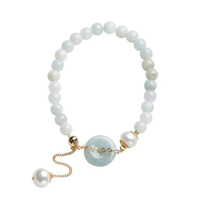 Natural jade bracelet with a geometric peace buckle clasp and round pendant.
