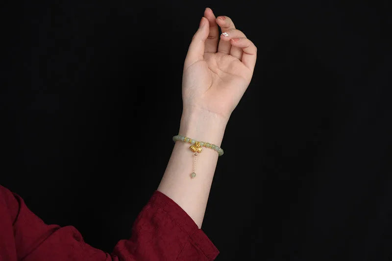 Natural Hetian jade bracelet with 6mm beads, engraved fu character, and constellation design on a simple string.