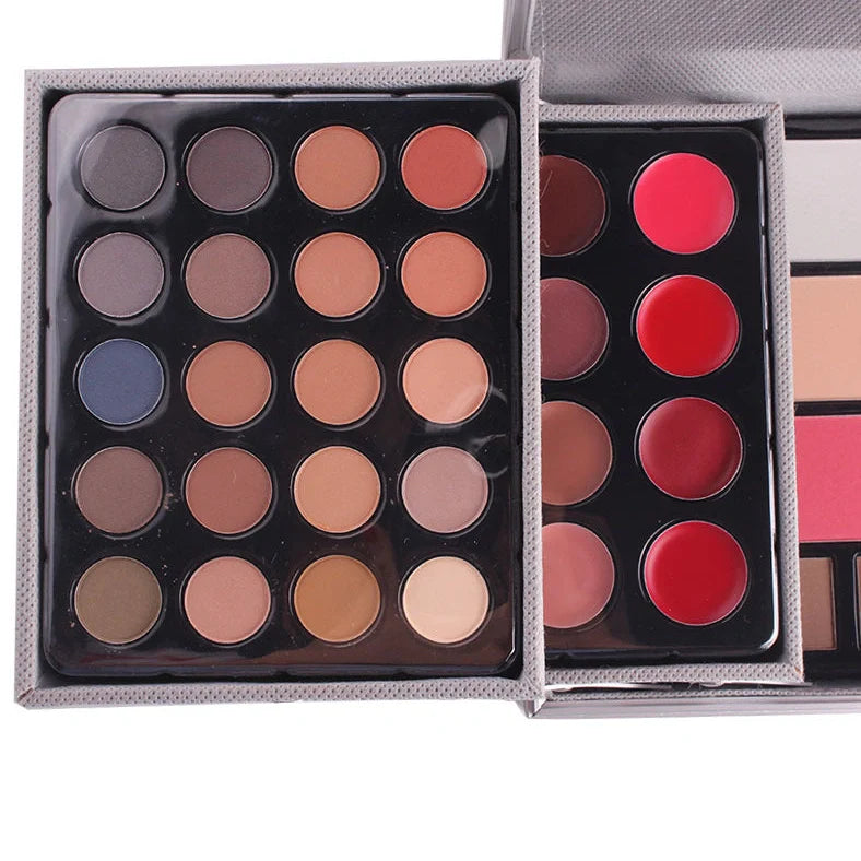 Multifunctional makeup artist kit showing 94 colour eye shadow palette with concealers, lipsticks, and application tools