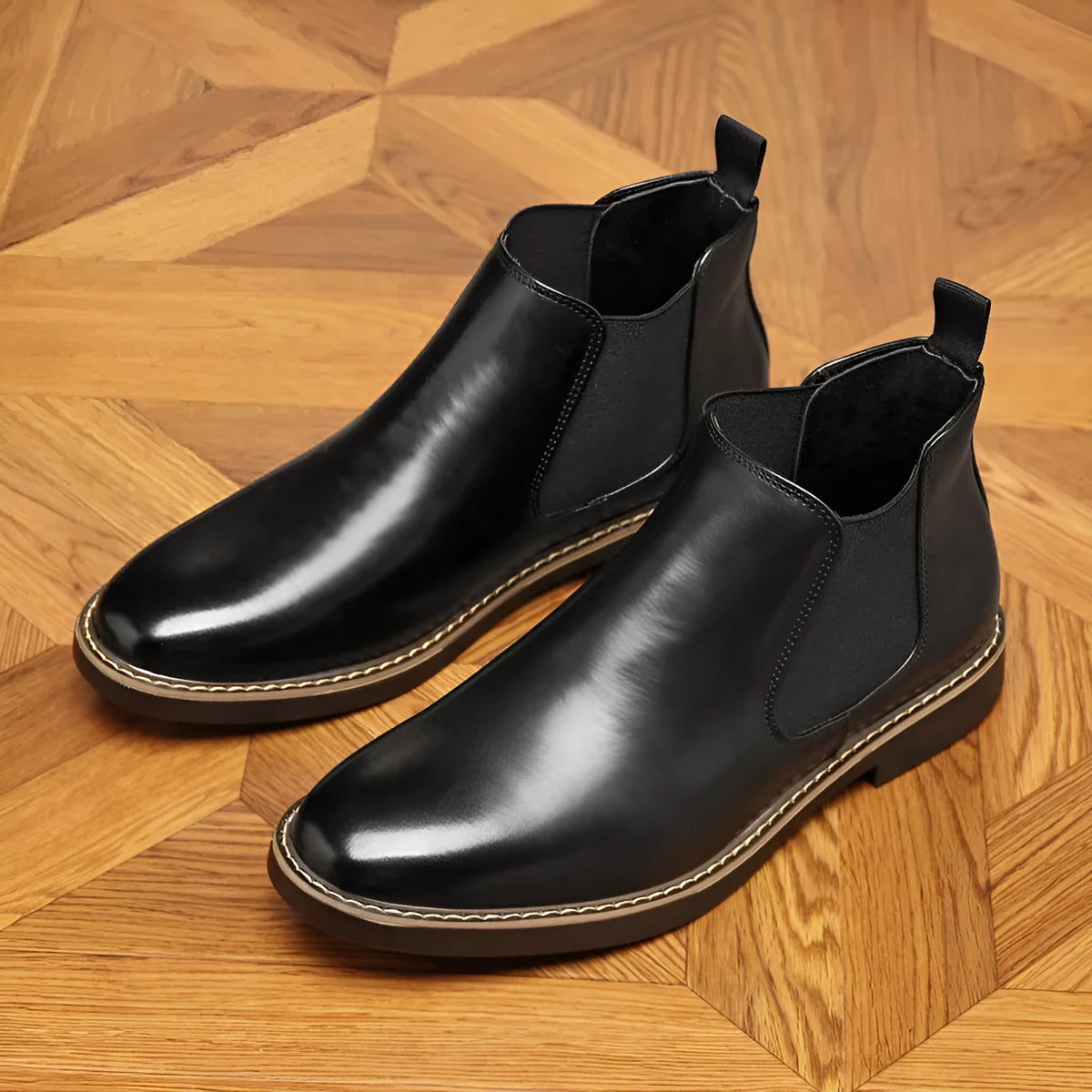 A pair of formal black leather pointed-toe boots with a square heel and rubber sole
