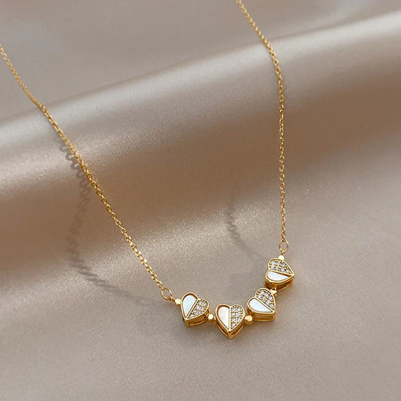 Exclusive four-leaf clover pendant necklace in stainless steel with crystal heart charm, a versatile jewellery piece for women