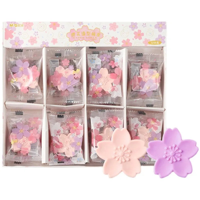 Assorted colourful cherry blossom shaped student erasers on a white background.