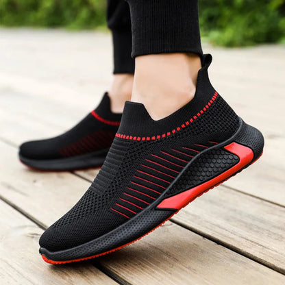 Men's black and white striped slip-on sneakers with lace-up front and mesh upper.
