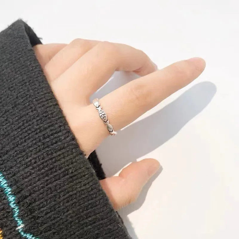 Women's adjustable sterling silver fish ring with detailed carp design on silver band