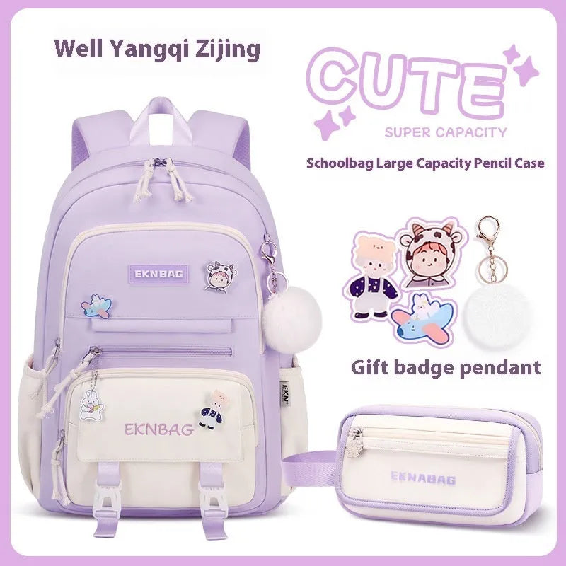 Pink waterproof Oxford cloth school backpack for girls with curved straps on a bookshelf.