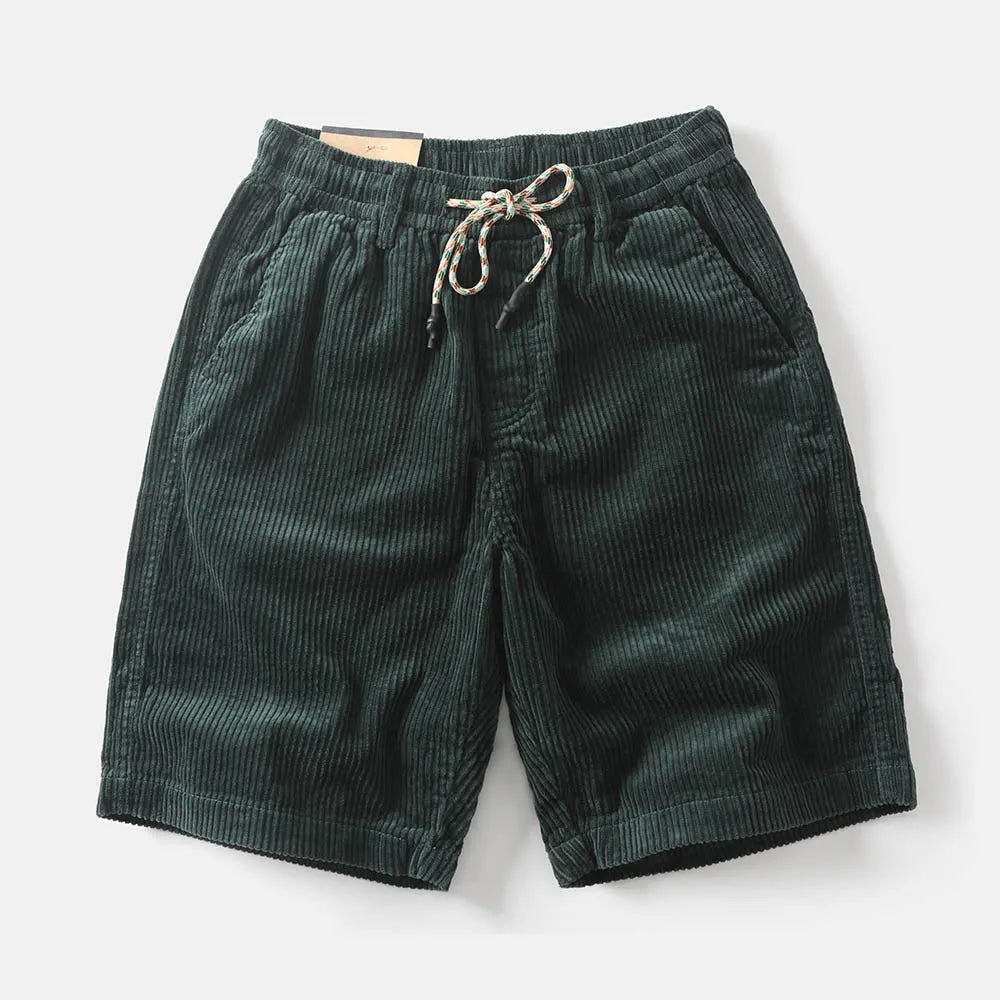 Men's khaki straight-leg cargo shorts with utility pockets, shown in a streetwear style.