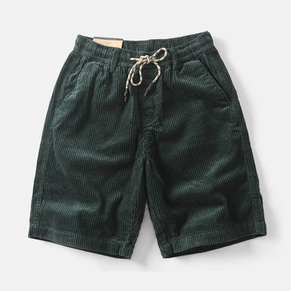 Men's khaki straight-leg cargo shorts with utility pockets, shown in a streetwear style.