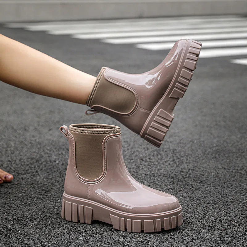 Women's creamy-white low tube PVC rain boots with a flat heel and thickening sole, shown from the side.