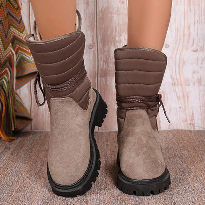 Women's black suede snow boots with chunky heel, fleece lining, and lace-up design for winter wear