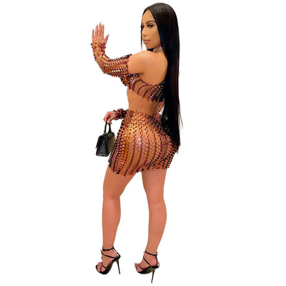 Women's black hollow-out two-piece set with sleeveless top and short skirt on a model.