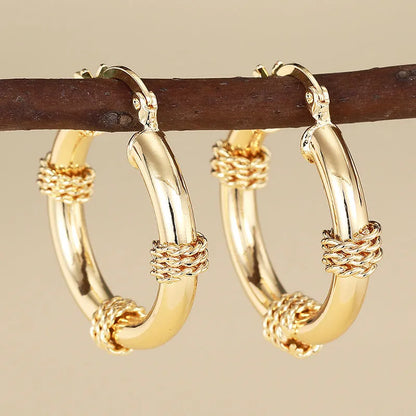 Geometric copper ear clips for women with ring and line elements in golden colours