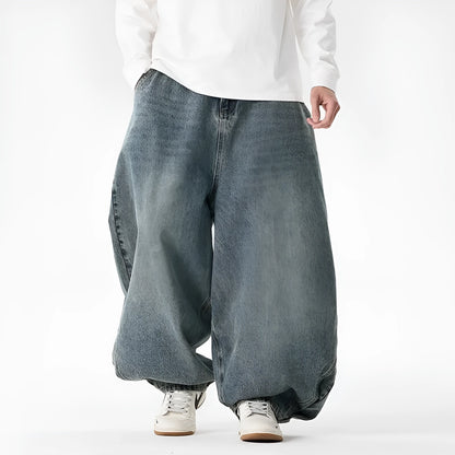 Men's plus-size light blue wide-leg baggy jeans on a neutral background.