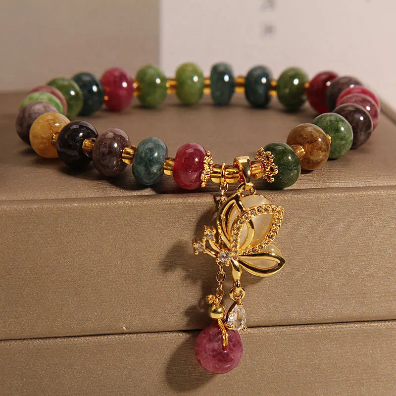 Close-up of a women's colourful butterfly bracelet with alloy construction, colourful beads, and tourmaline details.