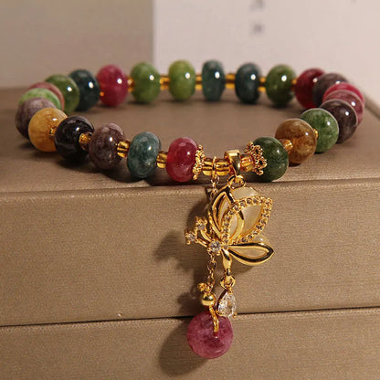Close-up of a women's colourful butterfly bracelet with alloy construction, colourful beads, and tourmaline details.