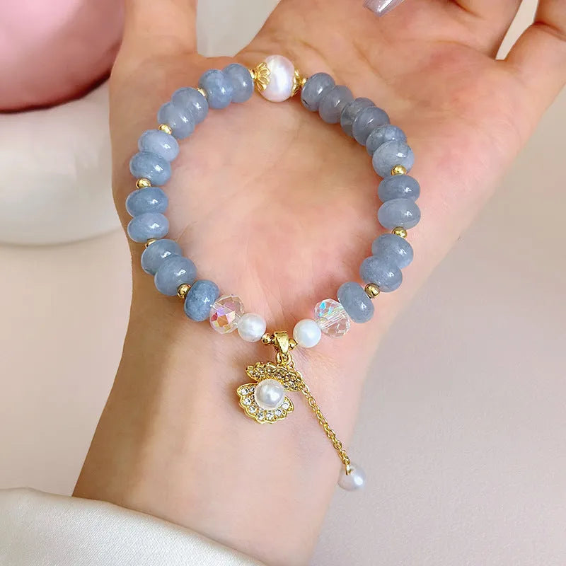 Natural aquamarine pearl bracelet with abalone shell charms on adjustable cord