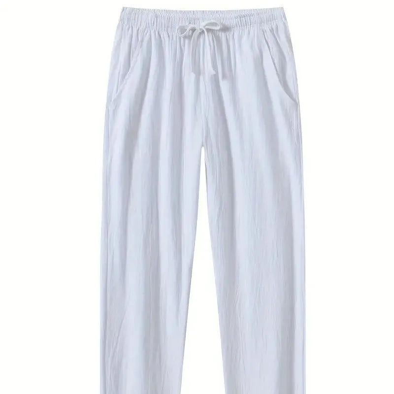 Man wearing loose-fitting cotton beach trousers in a solid colour, showcasing casual summer style.