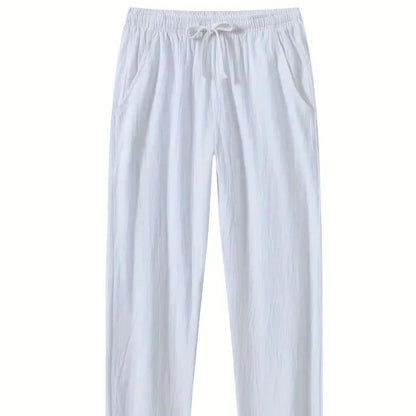 Man wearing loose-fitting cotton beach trousers in a solid colour, showcasing casual summer style.