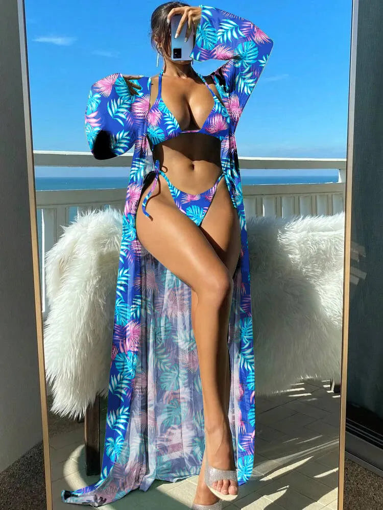 Polyester banded bikini set with long sleeve blouse, briefs, and robe cover-up in floral pattern