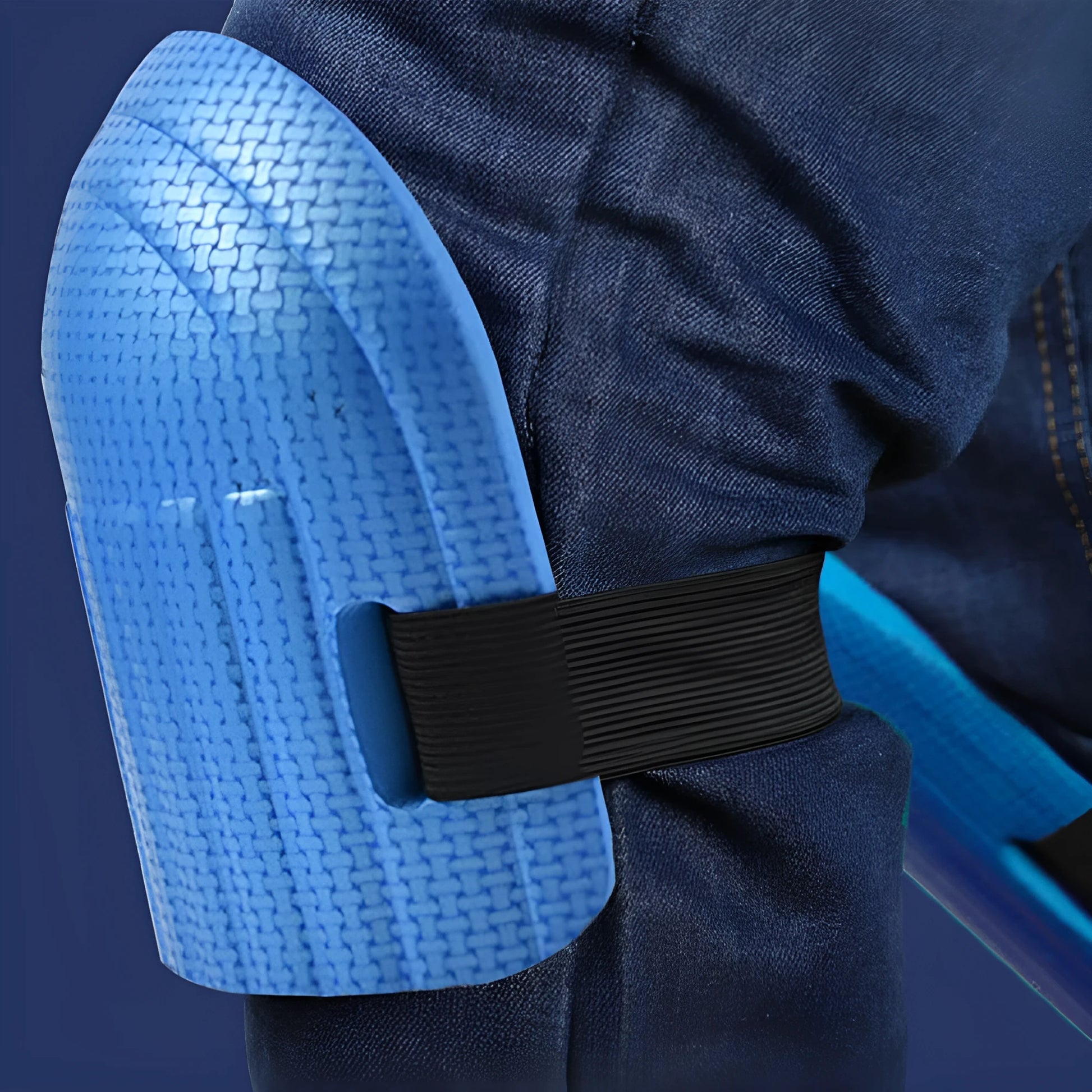 A pair of thick EVA foam kneepads in blue, shown on a tile floor.