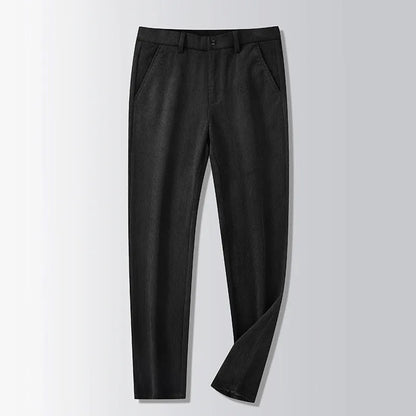 Man wearing khaki and black striped straight-leg retro trousers with a zip fly.