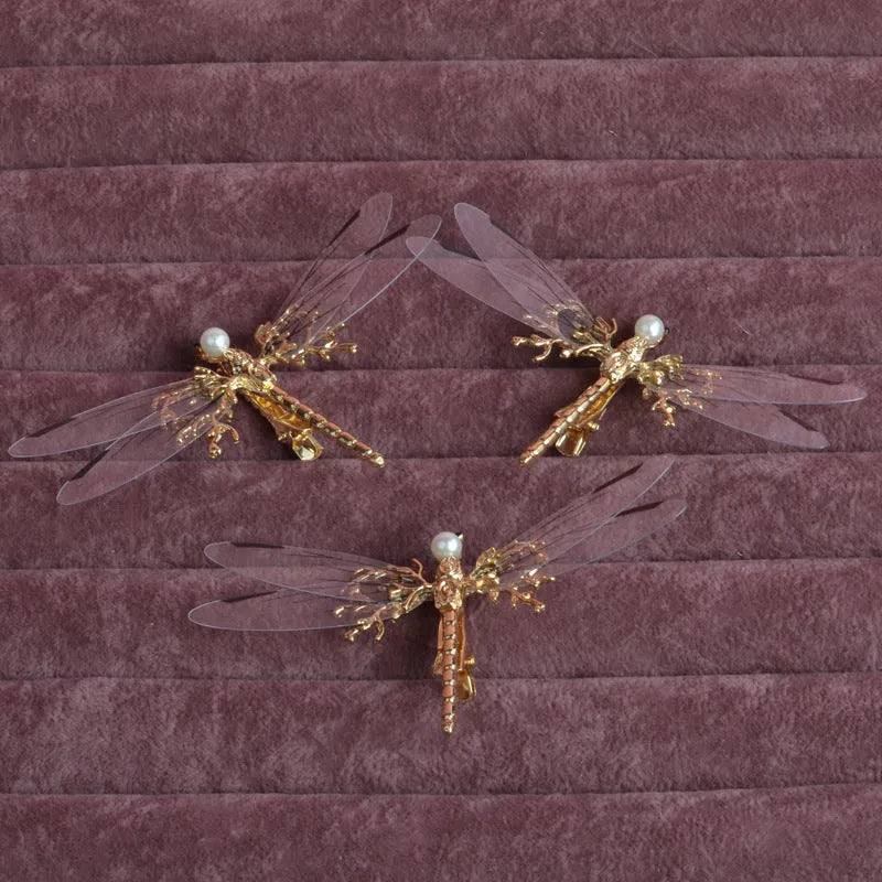 Golden dragonfly-shaped alloy hair clip with electroplated finish and a clip fastening.