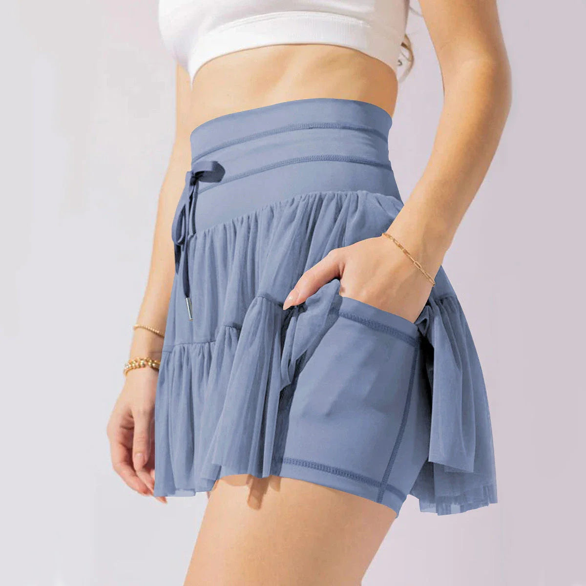 Stylish high-waist pleated skirt with lace-up accents in various colors, including black, gray, blue, apricot, pink, white, and purple