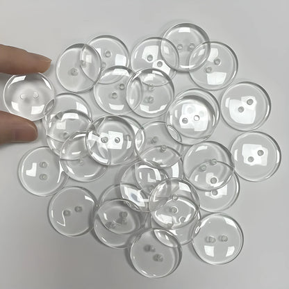 Transparent plastic resin sewing buttons with two holes, 10mm in diameter.