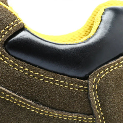 Bronze cow suede low-cut safety shoes with steel toe cap and patterned rubber sole on a workbench.