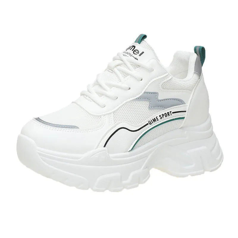 White women's dad sports trainers with cross straps and a lace-up front on a rubber sole.