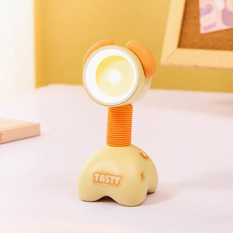 Colourful cartoon character magnetic DIY night light on a desk with adjustable head.