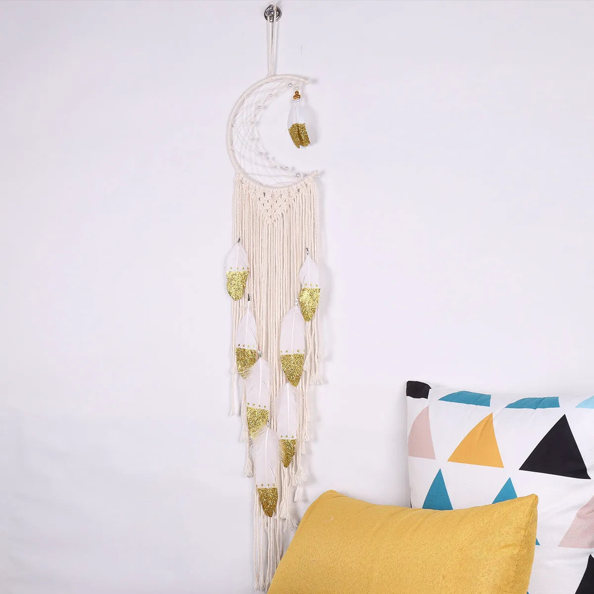 Gold crescent dream catcher wall decoration made from woven cotton thread, 20cm wide by 100cm high.