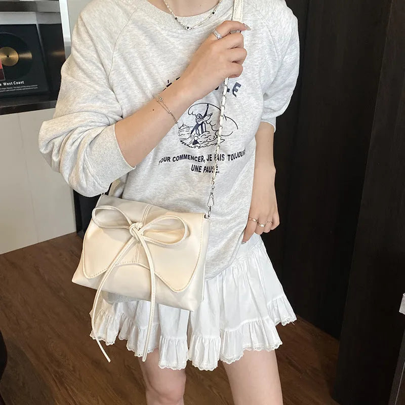 Black horizontal square PU crossbody bag showing internal mobile phone pocket and crossbody strap